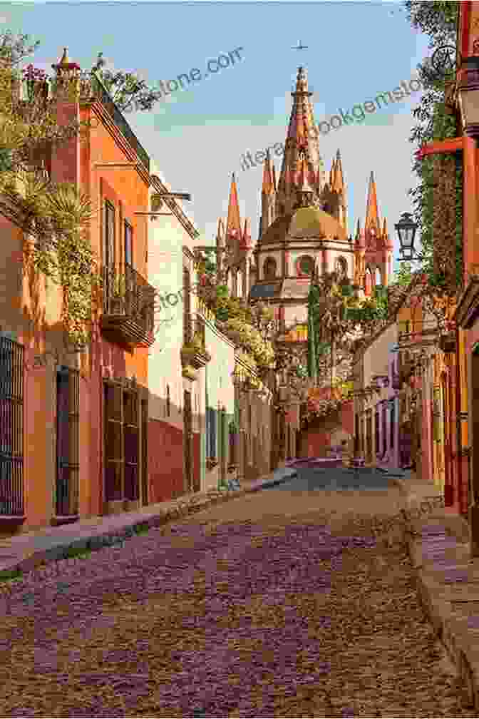 A Cobblestone Street In San Miguel De Allende, Mexico, With Colorful Buildings And A Church In The Background San Miguel De Allende Secrets: Town S Notorious